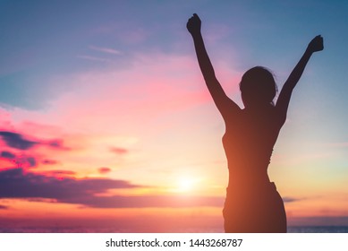 Happy woman standing arms outstretched back and enjoy life on the beach at Sea
 - Powered by Shutterstock