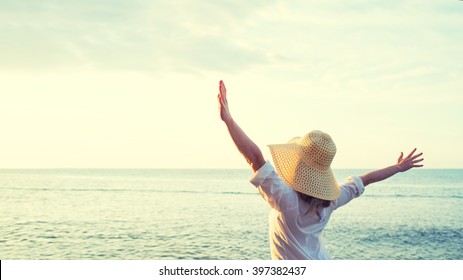 Happy Woman Standing Arms Outstretched Back And Enjoy Life On The Beach At Sea