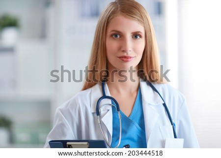 Happy woman is standing in the near window with folder