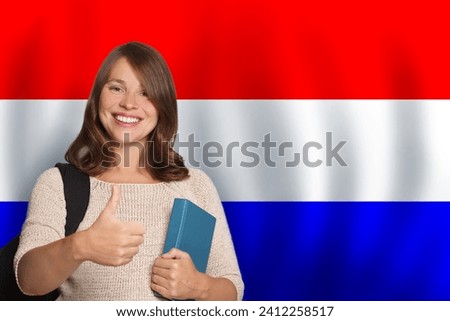Happy woman student against flag of Netherlands background. Travel, education and learn language concept