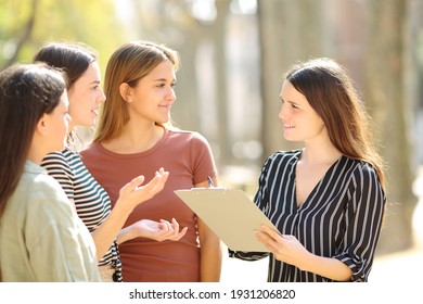 Happy woman surveying three people in the street a sunny day - Powered by Shutterstock