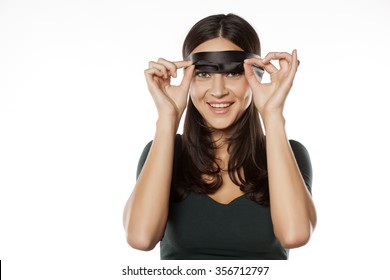 happy woman takes off the blindfold