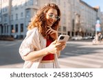 Happy woman tourist with phone. Young woman writing text for sharing content about vacations. Blogging, Lifestyle, travel, tourism, active life.