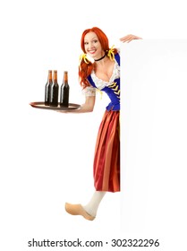 Happy Woman in a Traditional Oktoberfest Costume and a wooden shoe with Tray of Three Beer Bottles Holding a Sign, Isolated on White Background.