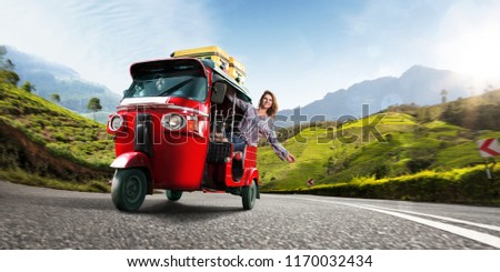 Happy woman travel by traditional srilankan transport, road near tea plantation in srilanka