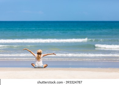 Happy woman traveler admiring her vacation on a perfect tropical beach