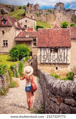 Happy woman traveling in France- Saint cirq lapopie village, Lot,Occitanie- One the Most of beautiful village in France