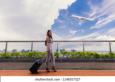 Happy Woman Traveling And Walking In Airport