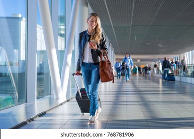 Happy Woman Traveling And Walking In Airport