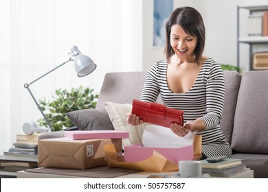 Happy Woman Unboxing A Parcel Containing A Fashion Bag, Online Shopping, Delivery And Customer Satisfaction Concept