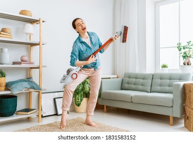 Happy Woman Vacuuming The Room. Housewife Doing The Cleaning In The House.