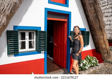 Happy Woman Visiting Madeira Island Rural Traditional House Village In Santana On A Beautiful Sunny Day. Madeira