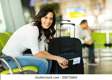 happy woman waiting for flight at airport