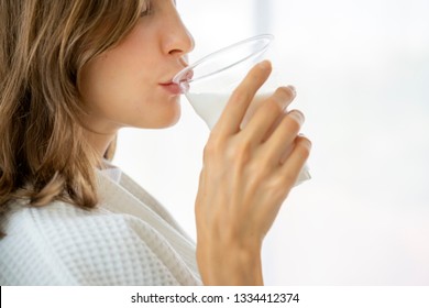 Happy Woman Wake Up In Early Morning, Breakfast Drinking Milk From A Glass  In Bed For Healthy Strong.  Lifestyle For Health Care  To Fulfilment Calcium,  Stronger Bones And Bright Skin For Health 