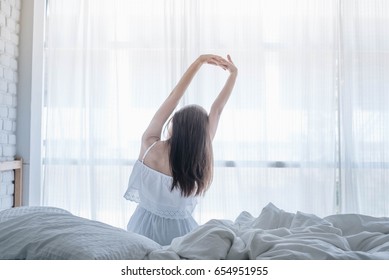 Happy Woman Wake Up On Her Bed In The Morning.