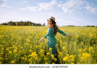 Happy woman walking in flowering field. Fashion, beauty concept. Summer landscape. - Powered by Shutterstock