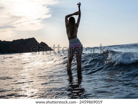 Happy woman walking on beach at sunset.Beautiful female happy relax walking on beach near sea when sunset in evening. Lifestyle women travel on beach concept.