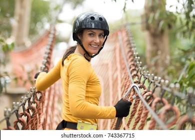 Happy woman walking on the rope bridge  - Powered by Shutterstock