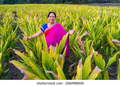 Happy Woman Walking In The Turmeric Field.