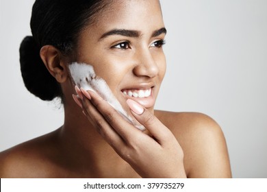 Happy Woman Wash Her Face With A Soap Foam