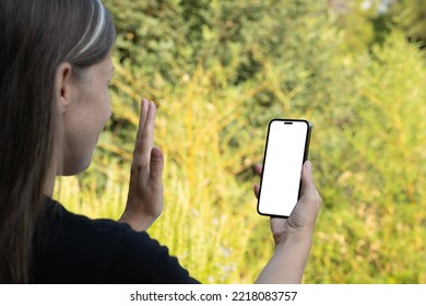 Happy Woman Wave Hand, Over Shoulder View Of Caucasian Blonde Happy Woman Wave Hand. Video Call, Online Talk Concept Idea.  Communication With Friend  Or Family Distantly. Vertical Smartphone Mock Up.