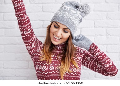 Happy Woman In Winter Clothes Raising Hand