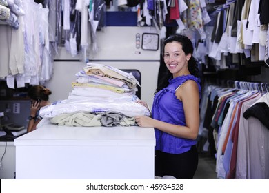 Happy Woman Working At A Dry Cleaner Store