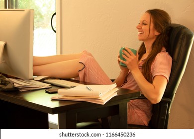 Happy Woman Working At Home Feet Up Wearing Pajamas Looking At Computer Smiling Sipping Coffee, Mobile Career Work From Home Lifestyle, Home Based Business Concept Freedom Fun Fulfilled Concept