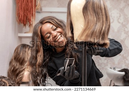 happy woman working in the wig salon
