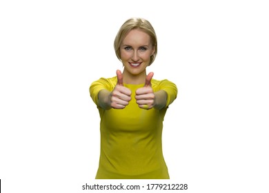 Happy Woman In Yellow Showing Okay With Both Hands On White Background. Young Lady Standing, Smiling With Outstretched Arms.