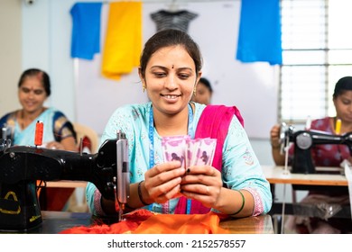 Happy Women Counting Indian Currency Notes At Garment Sewing Machine - Concept Of Business Profit, Bonus And Financial