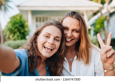 Happy women doing selphie by the smart phone outdoors