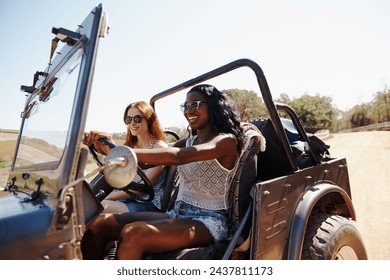 Happy women, excited and vacation with road trip in nature and bonding together for adventure in outdoor. Friends, driving or journey in convertible van on holiday, countryside or summer fun in texas - Powered by Shutterstock