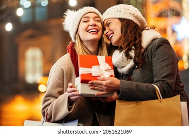 Happy women friends exchanging christmas present. Happiness people friend shopping xmas concept - Powered by Shutterstock