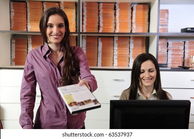 Happy Women Handing Over Dvd At The Video Rental Store