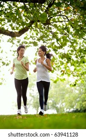 Happy Women Jogging At The Park - Fitness Concepts