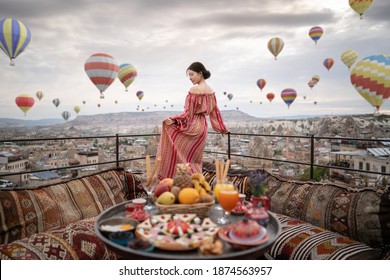 Happy women on rooftop of cave house enjoying of Goreme city panorama, Cappadocia Turkey. 3D - Powered by Shutterstock