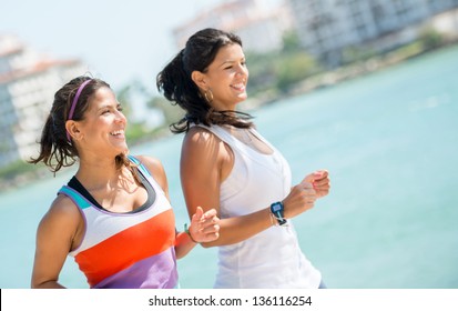 Happy Women Running Outdoors By The Beach - Fitness Concepts