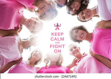 Happy women smiling in circle wearing pink for breast cancer against breast cancer awareness message