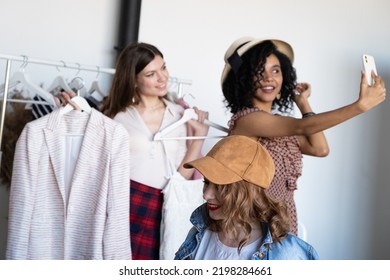 Happy Women Try On Things At At Fashion Store And Taking Selfie On Phone. Choose Casual Clothes, Shoes, Hats, Bags, Jewellery. Idea Of Exchange Old Wardrobe. Zero Waste Shopping, Reduce And Reuse