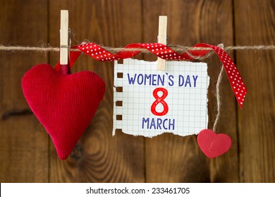 Happy Women's Day. Happy Women's Day on paper , hanging on a rope with red hearts. - Shutterstock ID 233461705