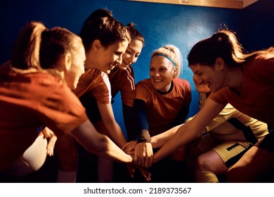 Happy Women's Soccer Team Gathering Hands In Unity In Dressing Room Before The Match.