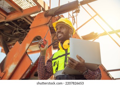 happy worker foreman working loading control in cargo shipping industry. engineer work in contruction site.