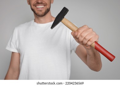 Happy Worker Holding Hammer On White Background, Closeup