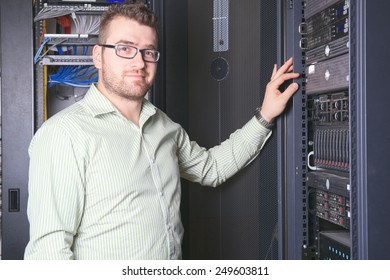 A happy worker technician at work with computer