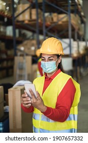 Happy Worker Women Using Mobile Phone Inside Warehouse - Focus On Face 