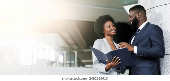 Happy of working together. A couple of young african american business partners smiling and making eye contact. Copy space - Powered by Shutterstock