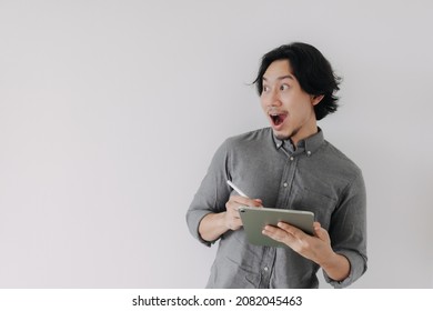 Happy Wow Face Asian Businessman Use Digital Tablet And Advertisement Space.