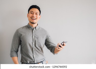 Happy and wow face of Asian man use smartphone.