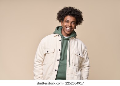 Happy young African American gen z guy isolated on beige background. Smiling hipster ethnic teen student, cool curly ethnic generation z teenager fashion model standing looking at camera, portrait. - Powered by Shutterstock